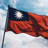 Taiwan flag with blue sky and clouds.